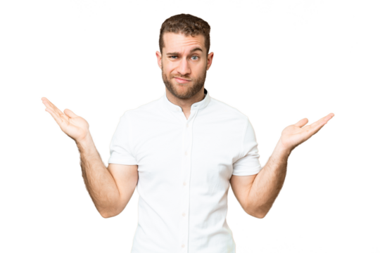 Young handsome blonde man over isolated chroma key background having doubts while raising hands