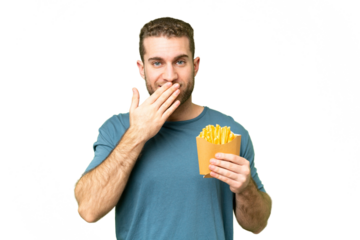Young handsome blonde man holding fried chips over isolated chroma key background happy and smiling covering mouth with hand
