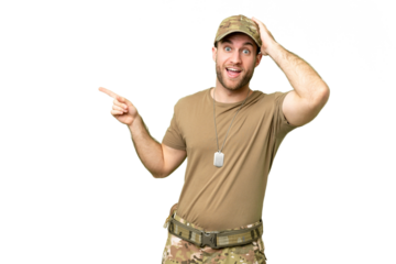 Military with dog tag over isolated chroma key background surprised and pointing finger to the side