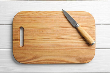 One sharp knife and board on white wooden table, top view