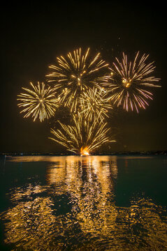 Italy, Veneto, Fireworks exploding over lake Garda at night