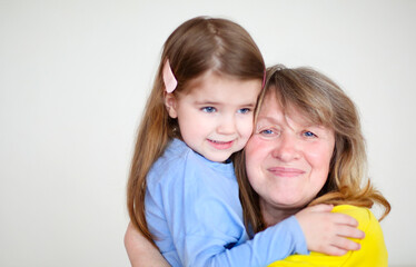 Happy woman with little girl at home