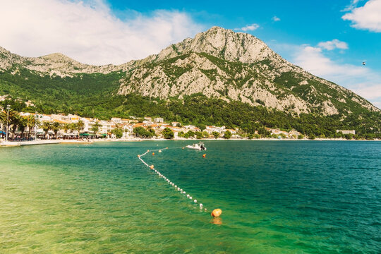 Croatia, Split-Dalmatia County, Drvenik, Buoys in front of coastal willage in summer