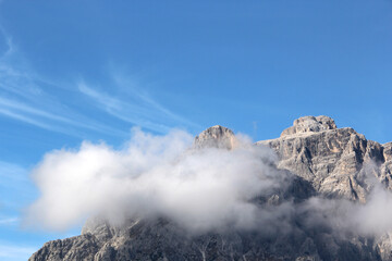 Fototapeta na wymiar Tremendous mountain peak in clouds