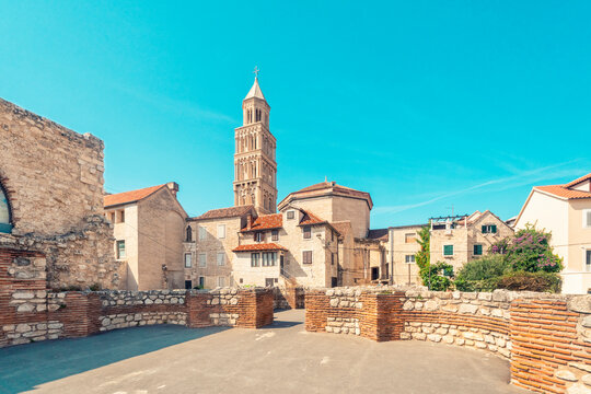 Croatia, Split-Dalmatia County, Split, Stone wall of Triclinium with houses and tower of Cathedral of Saint Domnius in background