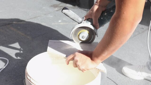 worker cutting tiles to tile terrace