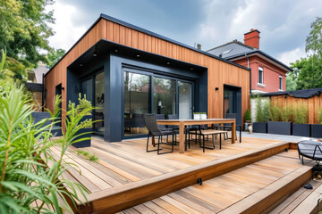 The exterior of a back garden patio area with wood decking, flowers garden