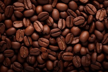 Close up view of dark fresh roasted coffee beans on coffee beans background. Closeup of coffee beans scattered background