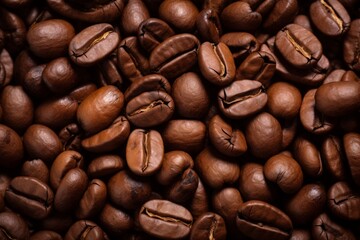 Close up view of dark fresh roasted coffee beans on coffee beans background. Closeup of coffee beans scattered background
