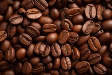 Fototapeta premium Close up view of dark fresh roasted coffee beans on coffee beans background. Closeup of coffee beans scattered background