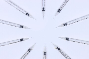 Insulin syringe with the needles pointed to the middle with a copy space in the center.
