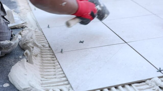 mature hispanic worker tiling roof