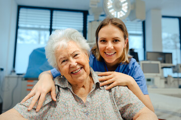 Portrait of nurse and senior patient talking in hospital corridor. Emotional support for elderly...