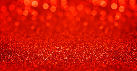 Sparkling red gold glitter background with bokeh. Closeup view, dof. Pattern with shining fine red...