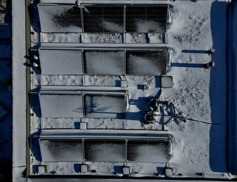 water heating in collectors on gable and flat roofs work when sun is shining. frost covered with layer of snow or frost must be plastered, otherwise effectiveness will recuced in row white silhoulett
