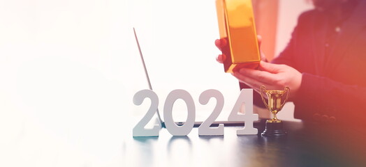 businessman buys gold using digital technology and laptop computer with forex chart and candlestick chart on screen. Finance and trade concept 2024. Double exposure