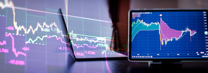 businessman buys Etf using digital technology and laptop computer with forex chart and candlestick...