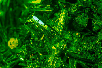 Green crystal mineral stone. Gems. Mineral crystals in the natural environment. Texture of precious...