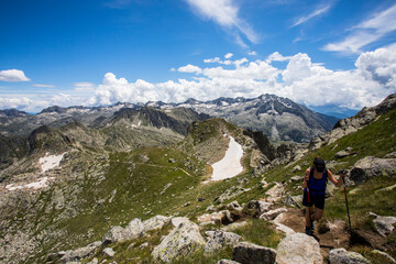 Young hiker girl summit to Montardo Peak in AIguestortes and Sant Maurici National Park, Spain