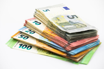 Pile of euro banknotes of 100, 50, 20, 10 and 5 euros. White background