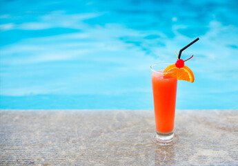 Glass of tropical cocktail on poolside