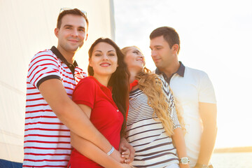 Smiling happy friends on yacht deck