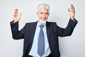 Portrait gray-haired man happy face smiling joyfully with raised palms and shocked open mouth isolated on white studio background.