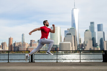 Runner training outside. Man run in NYC. Sport, jogging and running concept. New York City, Manhattan, Hudson, USA. Fitness sportswear. Outdoor Workout. Mature sportsman jogger. Training outside.