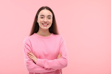 Beautiful woman with clean teeth smiling on pink background, space for text