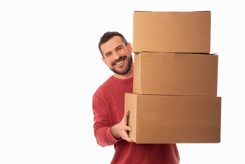 Smiling bearded man on white background holding large cardboard boxes. Delivery of packages. Home...