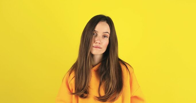 Fake, crying woman face in studio with hands gesture for sad, bullying or gesture on yellow background. Tears, face and female joke, cry and sign on mockup with unhappy boo emoji or fist of loser.