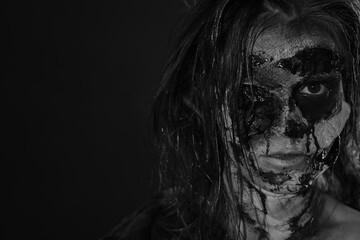 Scary zombie on dark background, black and white effect with space for text. Halloween monster