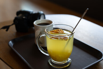View of a tangerine tea with a coffee and a camera
