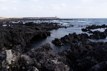 sea and rocks with the horizon in southern Jeju Island