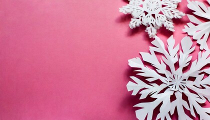 beautiful paper snowflakes on pink background copy space