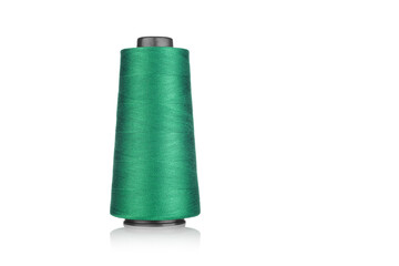 spool of industrial thread green color, texture of thread on a white background