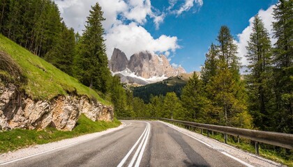 a fantastic image of an alpine road stretching through a larch forest dolomite alps south tyrol italy