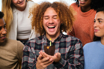 Young Latin man birthday party celebration with multiracial friends.