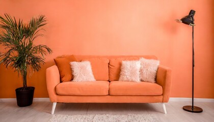 an orange couch with four pillows on top of it peach fuzz trendy color of the year 2024