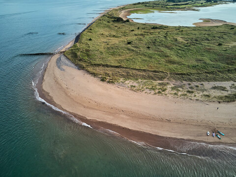 Aerial view of beach and dunes at Dawlish Warren, guarding the mouth of the River Exe, looking south along the coast towards the town of Dawlish, Devon, England