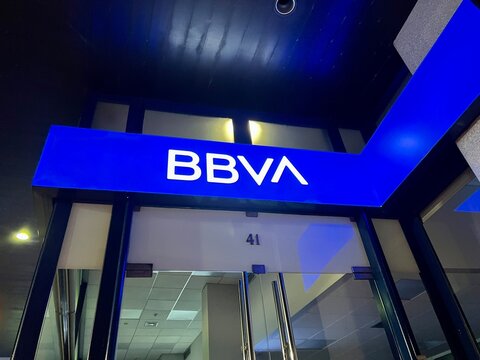 Porto, Portugal - 22 September, 2022: Fa&ccedil;ade of a BBVA bank branch illuminated at night.