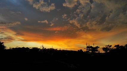 Background of silhouette urban area during beautiful cloudy sunset 