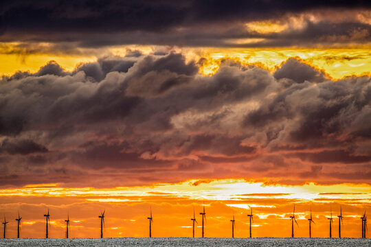 Sunset view from Walney Island across the Irish Dea towards the distant Walney Offshore Wind Farm, Cumbrian Coast, Cumbria, England