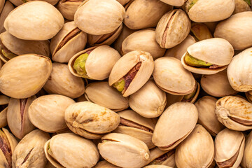 A small amount of delicious pistachios, macro, top view.