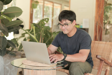 asian man work using computer hand typing laptop keyboard contact us.student study learning education online.adult professional people chatting search at office.concept for technology device business