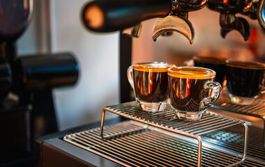 Professional espresso machine while preparing two espressos shot glass in a coffee shop. Espresso...