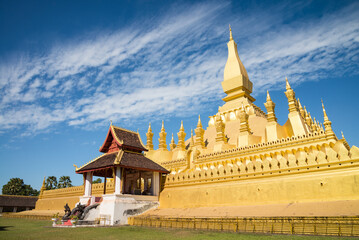 Beautiful large golden pagoda Pha That Luang temple famous landmark in Vientiane, Laos PDR sunny...