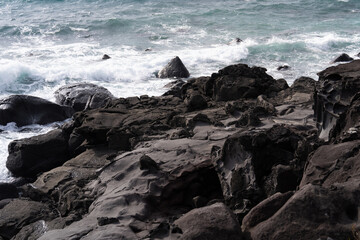 waves crashing on rocks at the seaside