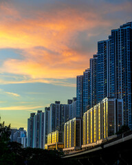 Urban scene with multiple tall buildings at sunset