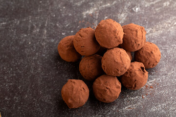 Horizontal photography showcasing handmade chocolate truffles. This gourmet confectionery is a delightful blend of Perfect for those with a taste for homemade and gourmet sweet treats.
